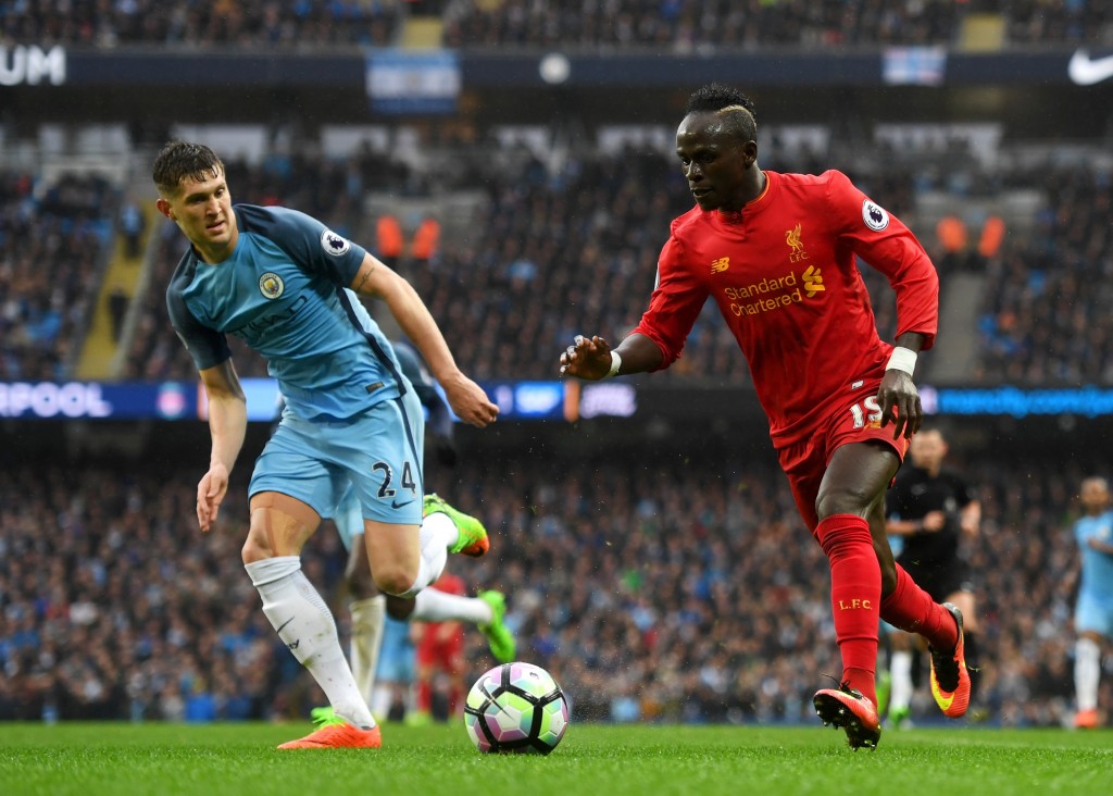 MANCHESTER, ENGLAND - MARCH 19: Sadio Mane of Liverpool (R) attempts to get past John Stones of Manchester City (L) during the Premier League match between Manchester City and Liverpool at Etihad Stadium on March 19, 2017 in Manchester, England.  (Photo by Michael Regan/Getty Images)